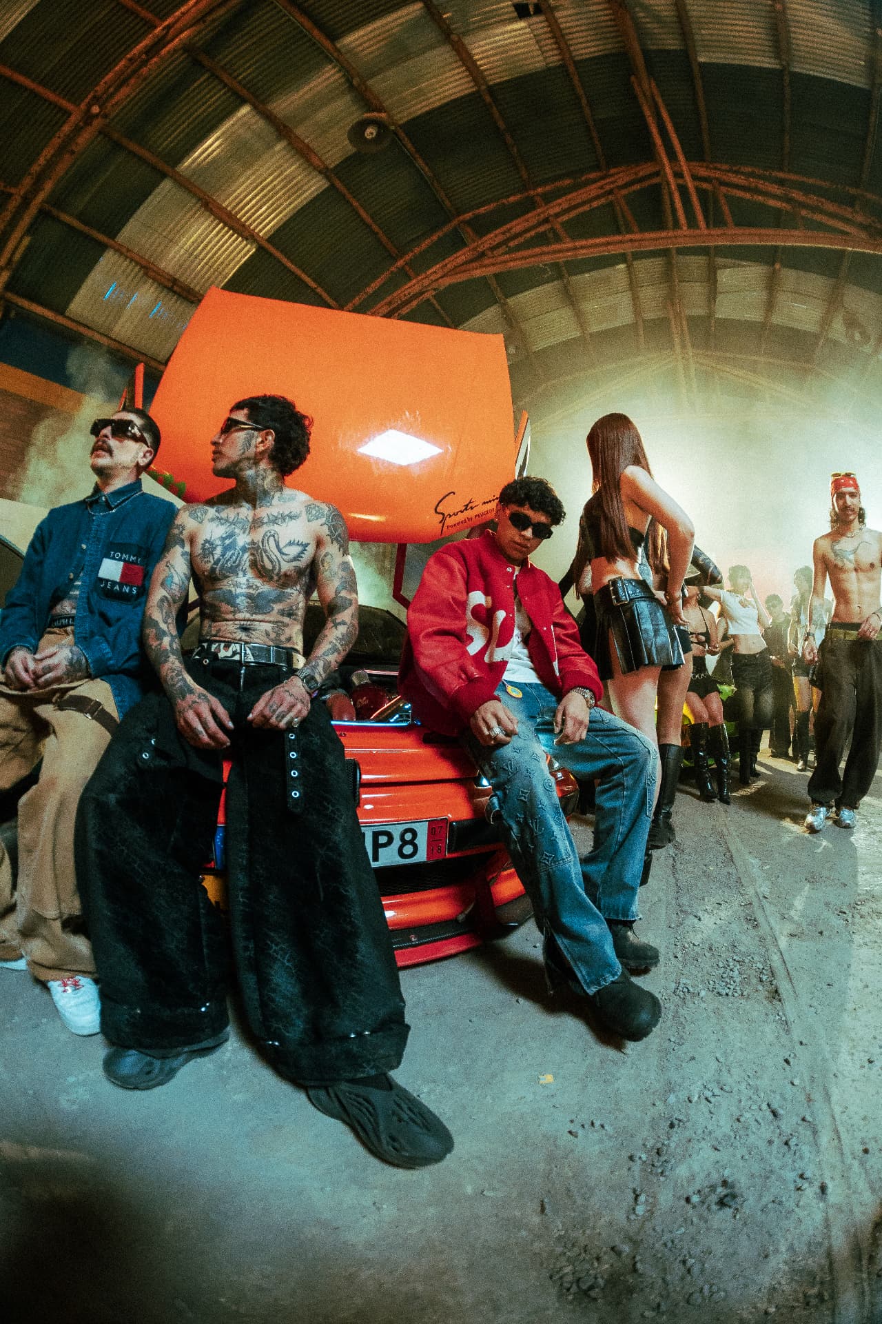 Cast seated on an orange car bonnet on the Reloxito set.