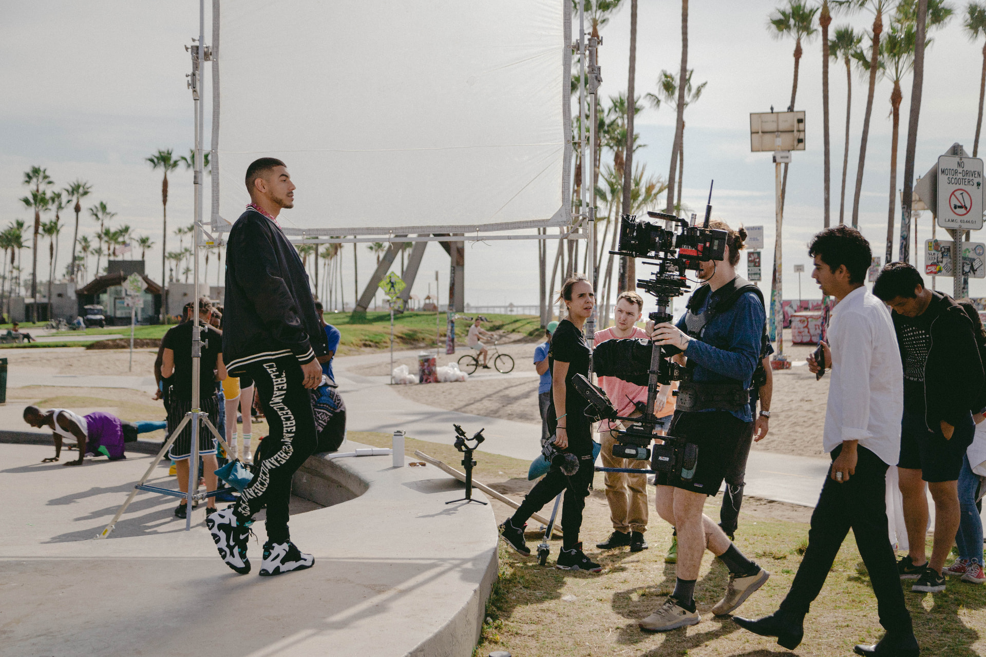 Wide view of the Venice Beach set with Steadicam operator and crew.