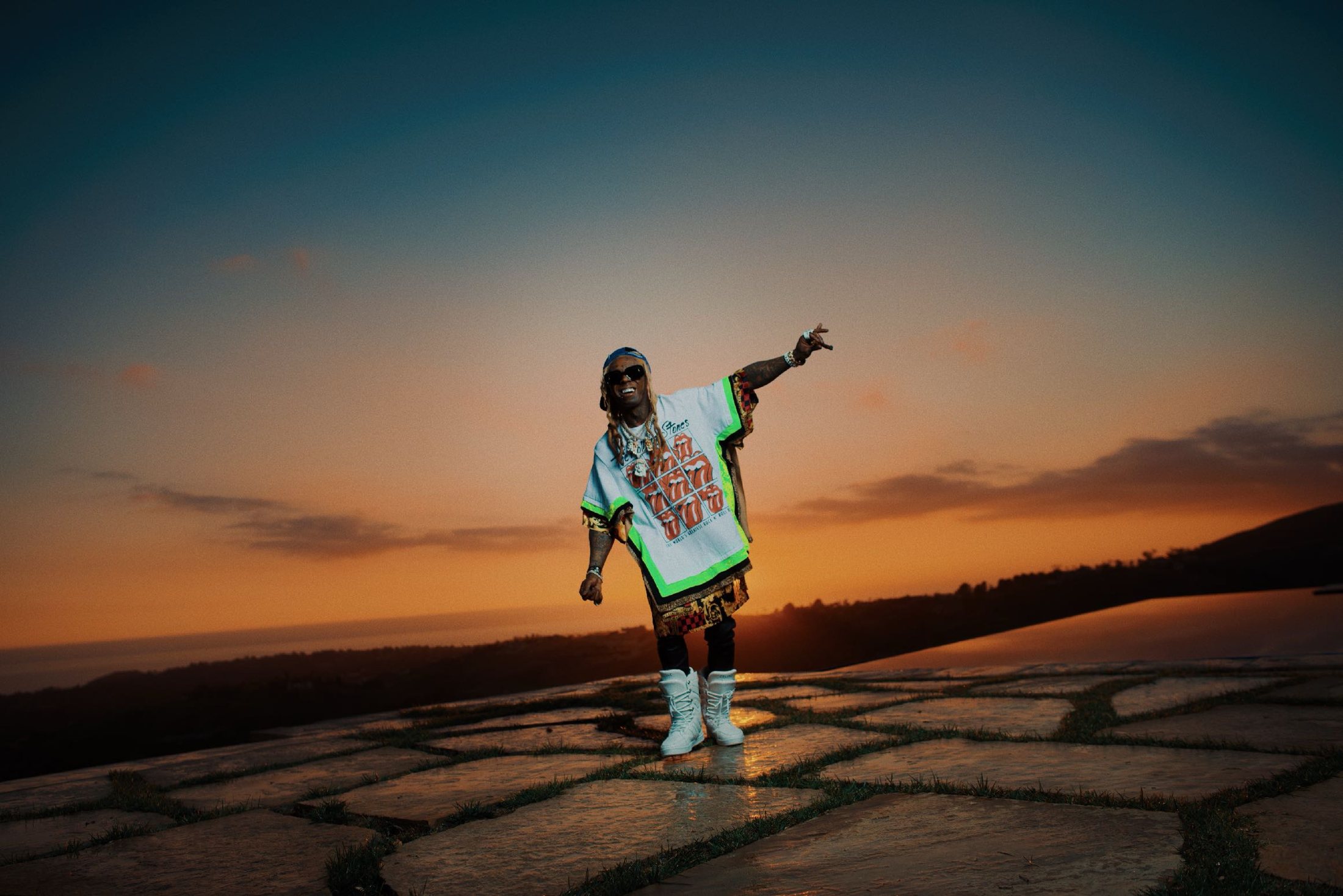 Recording artist photographed on a ridge at sunset.