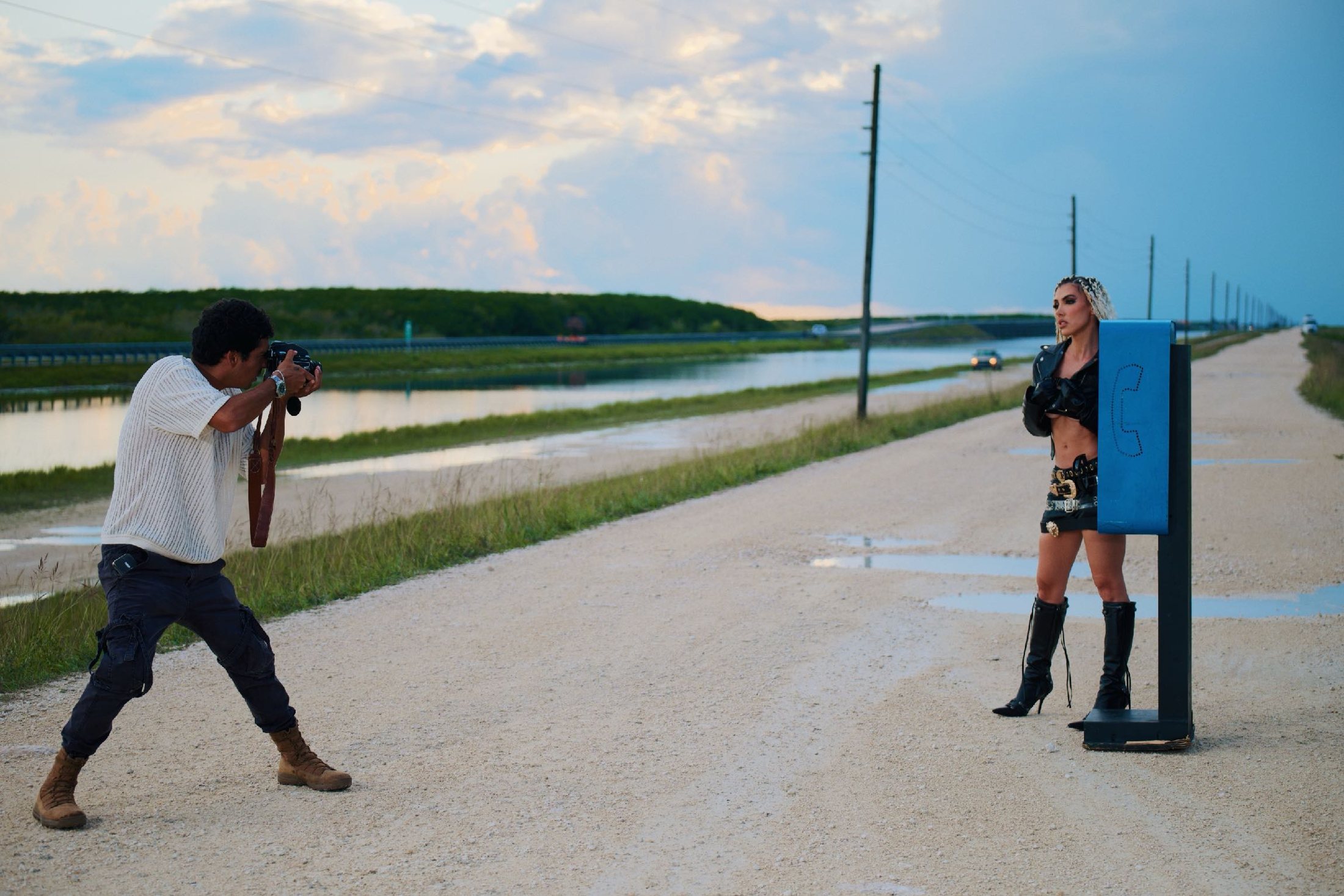 Photographer shooting a subject on an open service road.