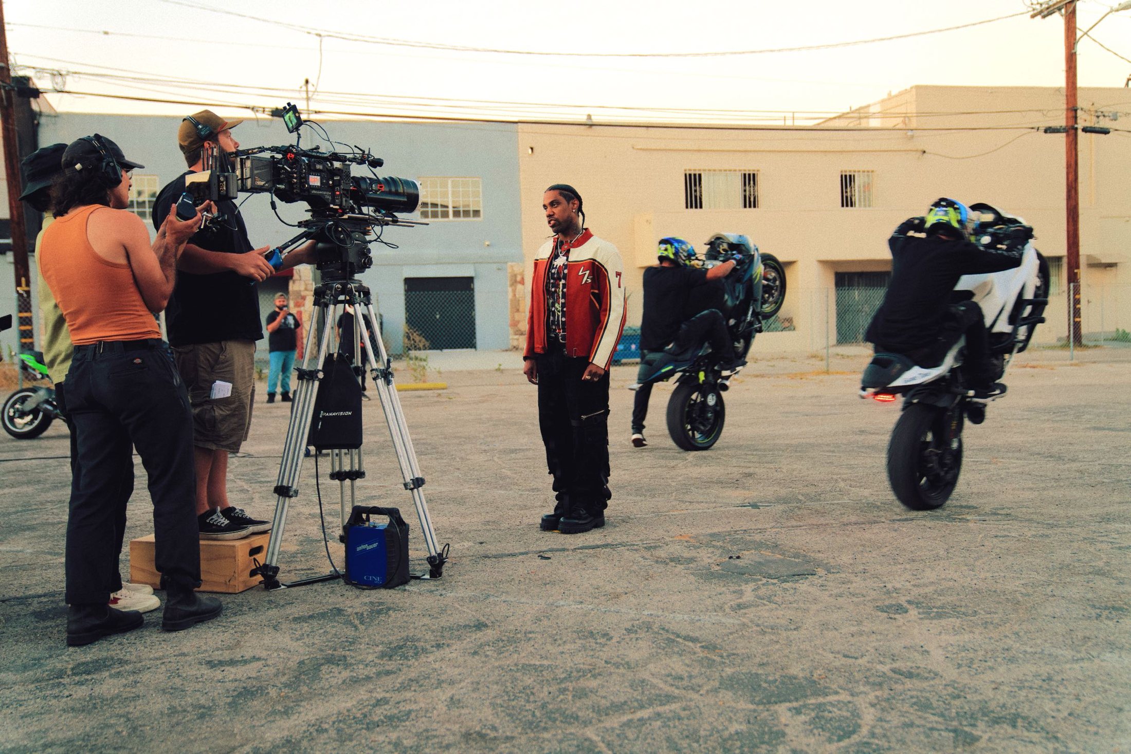 Crew operating a camera on sticks during an exterior shoot.